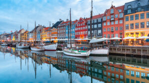 Nyhavn in Copenhagen, Denmark. with colourful facades of old houses and old ships in the Old Town of Copenhagen, capital of Denmark.