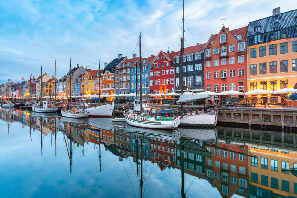 Nyhavn in Copenhagen, Denmark. with colourful facades of old houses and old ships in the Old Town of Copenhagen, capital of Denmark.