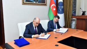 Two men signing an official agreement