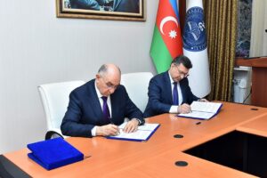 Two men signing an official agreement