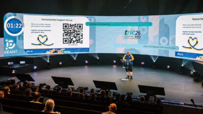 Man presenting on a large stage