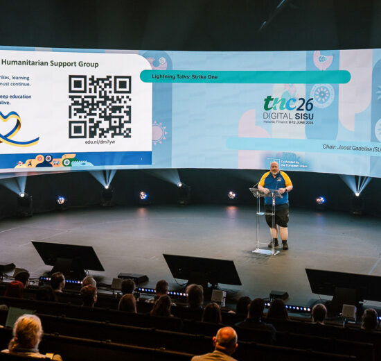 Man presenting on a large stage