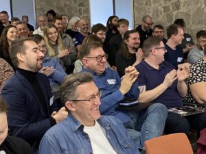 Audience clapping and smiling